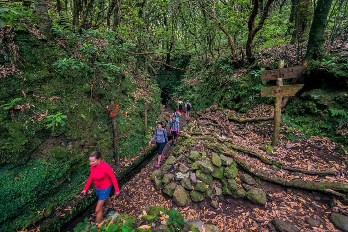 Dark tunnel section on levada trail PR9 Caldeirão Verde Madeira with headlamp visible