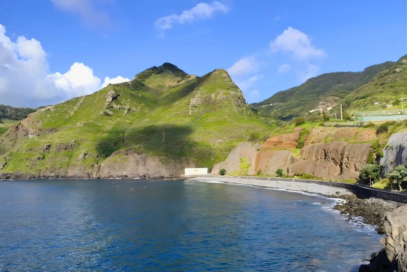 Porto da Cruz coastal village black sand beach dramatic cliffs Engenho do Norte sugarcane rum distillery working authentic fishing Madeira East