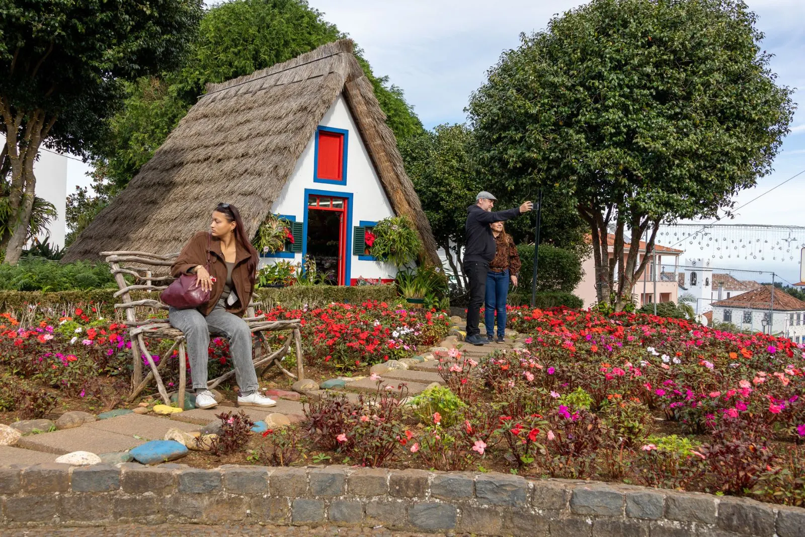 Santana traditional triangular thatched roof houses casas típicas bright colors red blue white steep roofs mountain rainfall Madeira East cultural identity