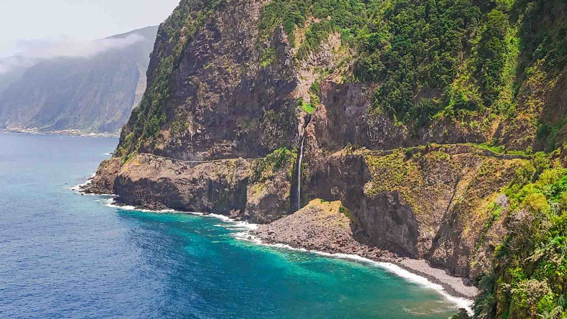 Véu da Noiva waterfall Bride's Veil cascading coastal cliffs Atlantic Ocean spray delicate fabric viewpoint Madeira West coast